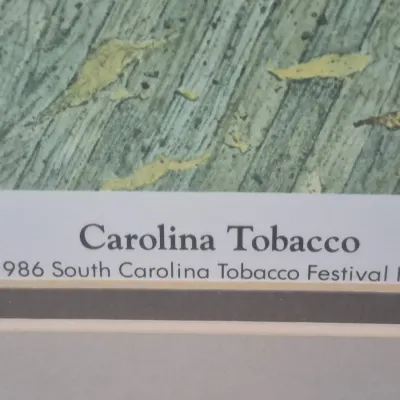 Sale Photo Thumbnail #481: Framed "Carolina Tobacco" art print created for the 1986 South Carolina Tobacco Festival, featuring double matting.