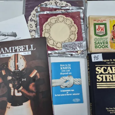 Sale Photo Thumbnail #151: Assortment of vintage paper ephemera, including an S&H Green Stamps saver book, a DuPont knot-tying pamphlet, Roylies paper doilies, and various books and magazines.