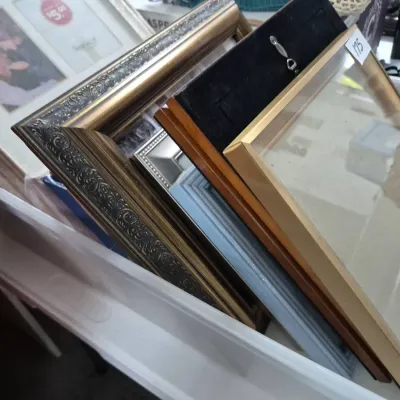 Sale Photo Thumbnail #303: Collection of assorted picture frames in various sizes, finishes, and materials including ornate metallic and modern thin wood designs.