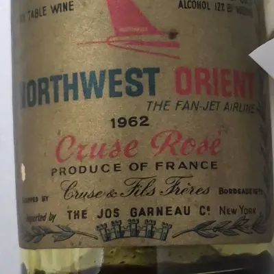 Sale Photo Thumbnail #709: Vintage 1962 miniature wine bottle featuring a Northwest Orient Airlines label for Cruse Rosé.