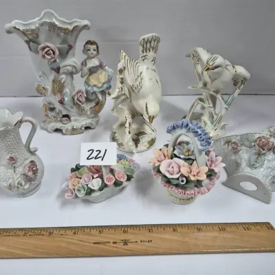 Sale Photo Thumbnail #380: Collection of vintage porcelain figurines and miniature vases, featuring bird sculptures, floral baskets, and gilt accents.