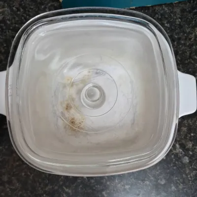Sale Photo Thumbnail #697: Vintage white CorningWare square casserole dish with a clear glass lid.