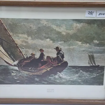 Sale Photo Thumbnail #516: Framed exhibition print of Winslow Homer's "Breezing Up (A Fair Wind)" housed in a simple wooden frame, measuring 21 x 18 inches.