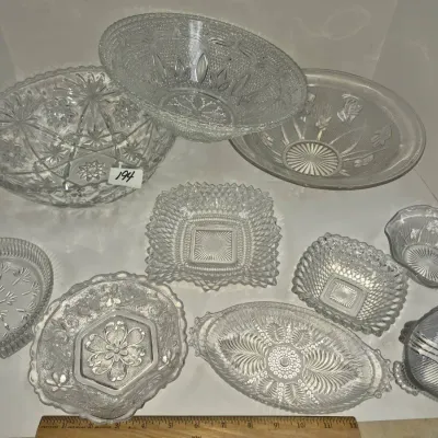 Sale Photo Thumbnail #333: Collection of clear pressed and cut glass bowls and serving dishes in various geometric and floral patterns.