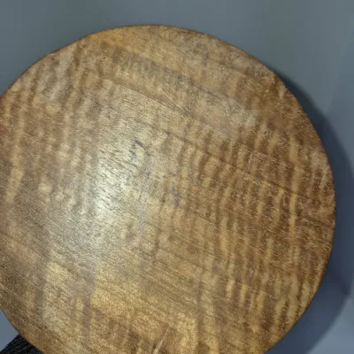 Sale Photo Thumbnail #271: Circular tiger maple or curly wood plaque with faint handwritten markings on the surface.