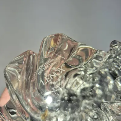 Sale Photo Thumbnail #350: Close-up detail of a Lenox crystal piece from the Wedding Promise Collection, showing the etched maker's mark and stylized glass petals.