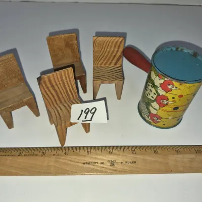 Sale Photo Thumbnail #340: Set of four handmade miniature wooden chairs paired with a vintage clown-illustrated lithographed tin shaker, displayed next to a wooden ruler for scale.
