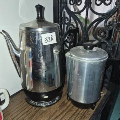 Sale Photo Thumbnail #572: Vintage General Electric chrome electric coffee percolator displayed alongside a smaller metal carafe.