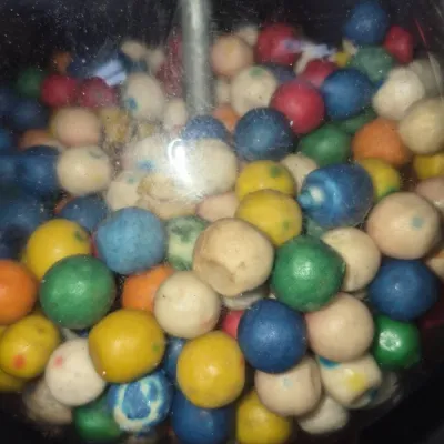 Sale Photo Thumbnail #17: Vintage clear glass gumball machine globe filled with colorful, aged gumballs.