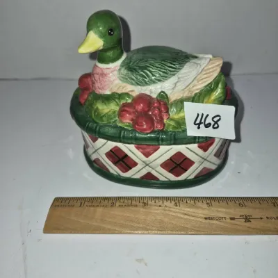 Sale Photo Thumbnail #806: Vintage ceramic mallard duck trinket dish or lidded box featuring a festive holly and berry rim above a diamond-patterned base.