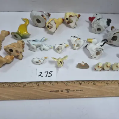 Sale Photo Thumbnail #466: Collection of miniature ceramic bird and duck figurines shown upside down to display bottom maker marks.