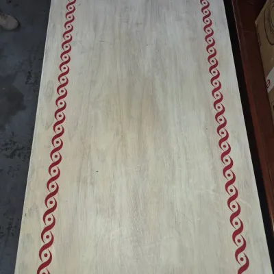 Sale Photo Thumbnail #62: Hand-painted wooden tabletop featuring a distressed white finish and a decorative red guilloche border.