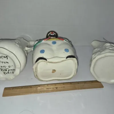 Sale Photo Thumbnail #743: Trio of vintage hand-painted ceramic pitchers, including a polka-dot clown figurine pitcher and one with an inscription dated 1961.