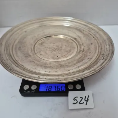 Sale Photo Thumbnail #905: Tarnished silver-toned round dish or tray displayed on a digital scale showing a weight of 187.60 grams.