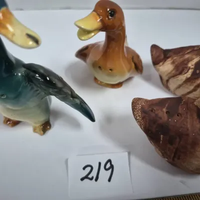 Sale Photo Thumbnail #377: Collection of ceramic duck salt and pepper shakers, including glazed mallard figures and brown marbleized finish pieces.