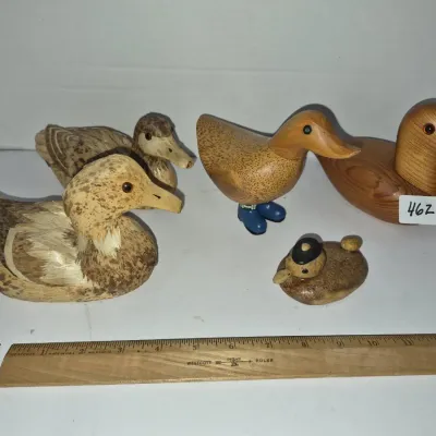 Sale Photo Thumbnail #798: Collection of five vintage carved wood and straw duck figurines in various sizes and styles, shown alongside a 12-inch ruler for scale.