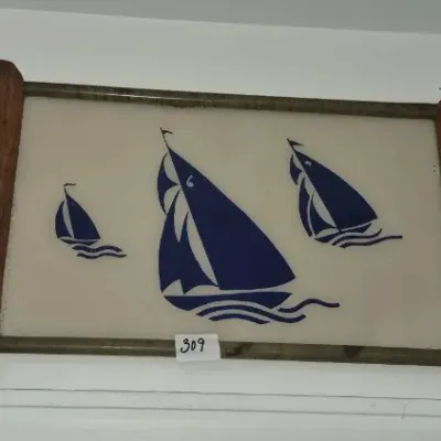 Sale Photo Thumbnail #544: Trio of decorative wall displays including a framed sailboat graphic glass tray, a reticulated Rock City souvenir plate, and a 1984 Louisiana World Exposition commemorative plate.
