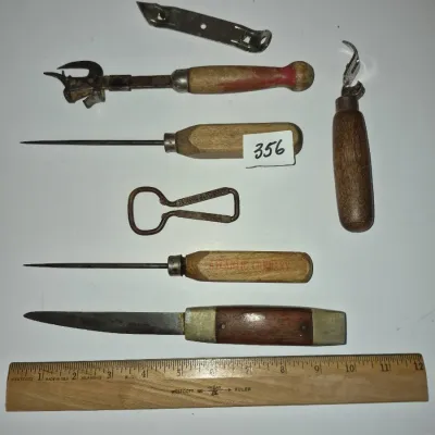 Sale Photo Thumbnail #619: Collection of vintage hand tools including ice picks with wooden handles, bottle openers, a small utility knife, and a Westcott wooden ruler.