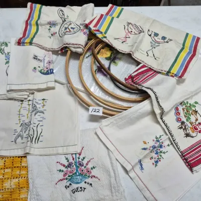 Sale Photo Thumbnail #201: Collection of vintage hand-embroidered linens, guest towels, and embroidery hoops, featuring playful mid-century patterns and floral designs.