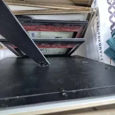 Sale Photo Thumbnail #302: Stack of assorted picture frames including metallic gold-tone and black tabletop frames in various sizes.