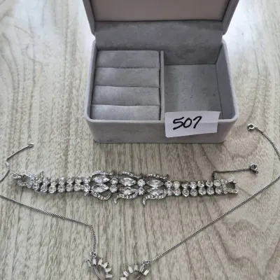 Sale Photo Thumbnail #874: Vintage rhinestone bracelet and delicate silver-tone necklace set, displayed with a velvet-lined gray jewelry box.