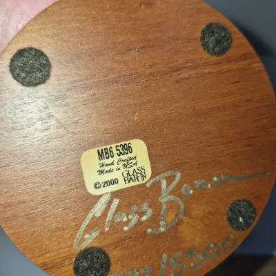 Sale Photo Thumbnail #236: Underside of a Glass Baron wooden display base, featuring an original maker's label, hand-signed signature, and edition number 377/5500 dated 2000.