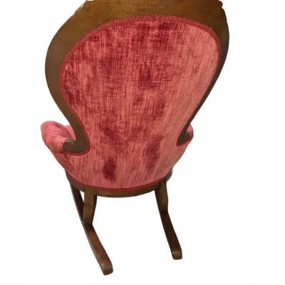 Sale Photo Thumbnail #105: Vintage Victorian-style wooden rocking chair with carved top crest and pink velvet upholstery, seen from the back.