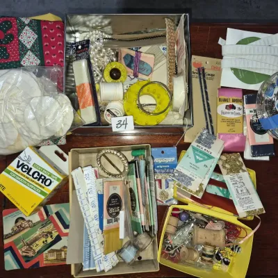 Sale Photo Thumbnail #51: Large collection of vintage sewing supplies, including spools of thread, trims, ribbons, Velcro tape, measuring tapes, and notions stored in various tins and boxes.
