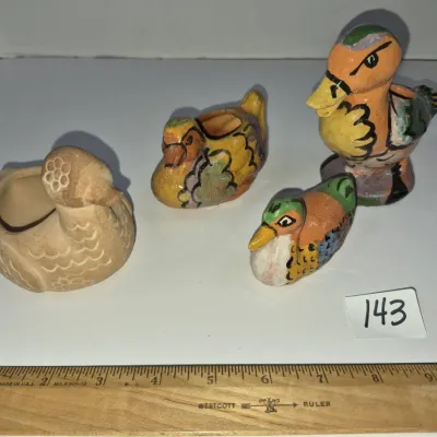 Sale Photo Thumbnail #242: Collection of four vintage hand-painted ceramic bird figurines and small planters, featuring colorful duck and fowl motifs.