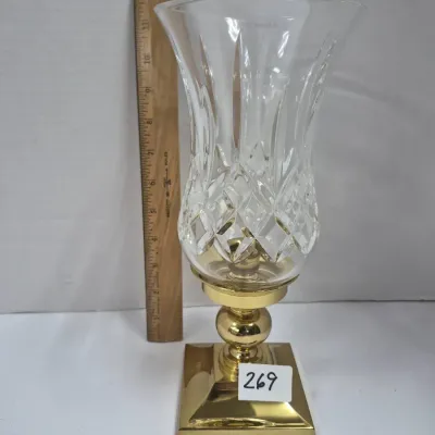 Sale Photo Thumbnail #457: Vintage hurricane candle holder featuring a cut crystal glass shade and a polished brass pedestal base, standing approximately 12 inches tall.