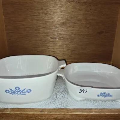 Sale Photo Thumbnail #698: Vintage Corning Ware white casserole dish and shallow baker, featuring classic blue floral motifs.