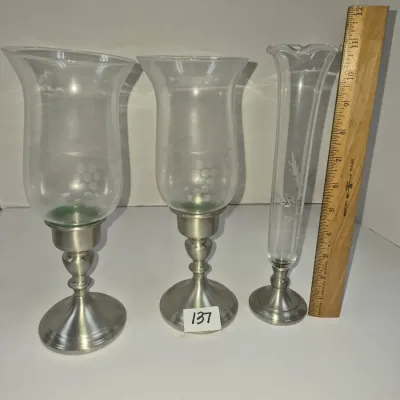 Sale Photo Thumbnail #228: Set of three silver-tone candle and flower holders featuring etched glass hurricane globes and a slender bud vase base.