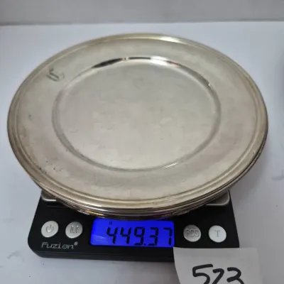 Sale Photo Thumbnail #903: Round silver plate displayed on a digital scale showing a weight of 449.37 grams.
