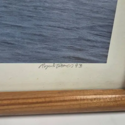 Sale Photo Thumbnail #533: Pencil-signed framed artwork depicting a water scene, dated 1993, presented in a natural wood frame.