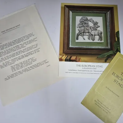Sale Photo Thumbnail #591: Franklin Mint collector literature for "The European Stag" silver wall sculpture by Donald Richard Miller, including a promotional sheet, picture print, and informational pamphlet.