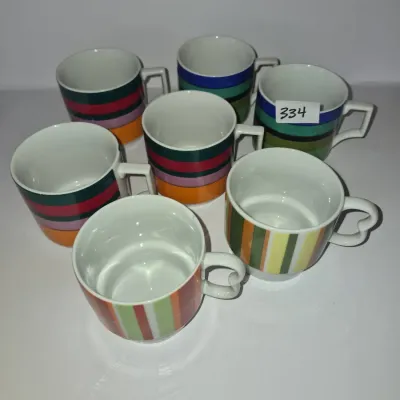 Sale Photo Thumbnail #582: Set of seven vintage colorful striped ceramic mugs in various horizontal and vertical stripe patterns, shown in good condition.