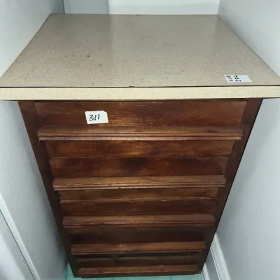Sale Photo Thumbnail #546: Vintage dark wood cabinet with a light speckled laminate top and multiple horizontal front panels.