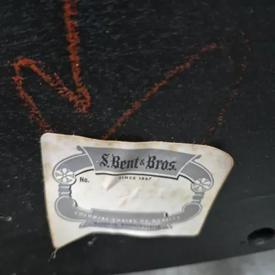 Sale Photo Thumbnail #190: Close-up of an S. Bent & Bros. manufacturer's label affixed to the underside of a dark wood furniture piece.
