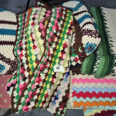 Sale Photo Thumbnail #78: Collection of handmade vintage crochet afghans and blankets featuring colorful geometric and chevron patterns.