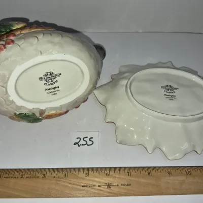 Sale Photo Thumbnail #436: Fitz and Floyd Classics 'Huntington' handcrafted ceramic teapot and underplate set showing maker's marks, measured against a 12-inch wooden ruler.