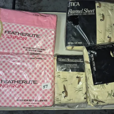 Sale Photo Thumbnail #90: Vintage packaged bed sheets and pillowcases, including Cannon Royal Family pink Featherlite sets and Utica duck-patterned flannel sheets.
