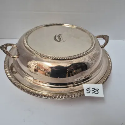 Sale Photo Thumbnail #920: Vintage silver-plated covered serving dish featuring a rope-twist border trim, side handles, and a monogrammed lid.