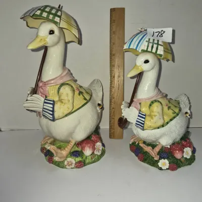 Sale Photo Thumbnail #307: Pair of vintage ceramic Jemima Puddle-Duck style figurines holding umbrellas, shown next to a ruler for scale.