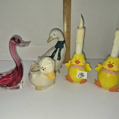 Sale Photo Thumbnail #335: Collection of bird-themed decor including a pink art glass duck, ceramic duck figurines, and a pair of yellow chick candle holders.