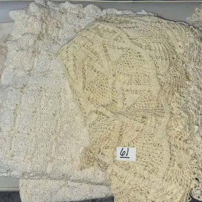 Sale Photo Thumbnail #94: Collection of vintage white and cream lace and crocheted linens, featuring intricate openwork patterns and an embroidered cloth.