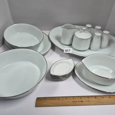Sale Photo Thumbnail #354: Vintage white fine china serving set with silver trim, including serving bowls, a platter, creamer, sugar bowl, and salt and pepper shakers.