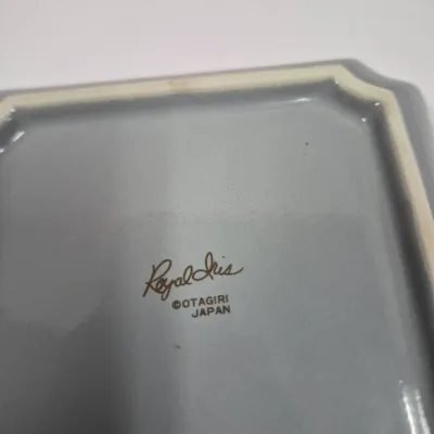 Sale Photo Thumbnail #397: Underside maker's mark on a grey ceramic tray or dish reading "Royal Iris Otagiri Japan".