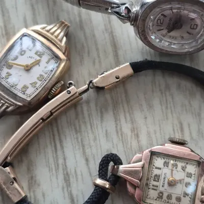 Sale Photo Thumbnail #881: Trio of vintage women's wristwatches including brands by Lady Elgin, Benrus, and Zodiac, featuring classic mid-century designs with metal and cord straps.