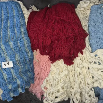 Sale Photo Thumbnail #72: Collection of handmade vintage knitted and crocheted shawls and blankets in various colors, including blue, red, cream, and pink.