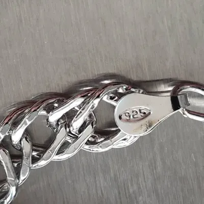 Sale Photo Thumbnail #847: Close-up of a sterling silver chain bracelet showing a 925 purity hallmark stamp.